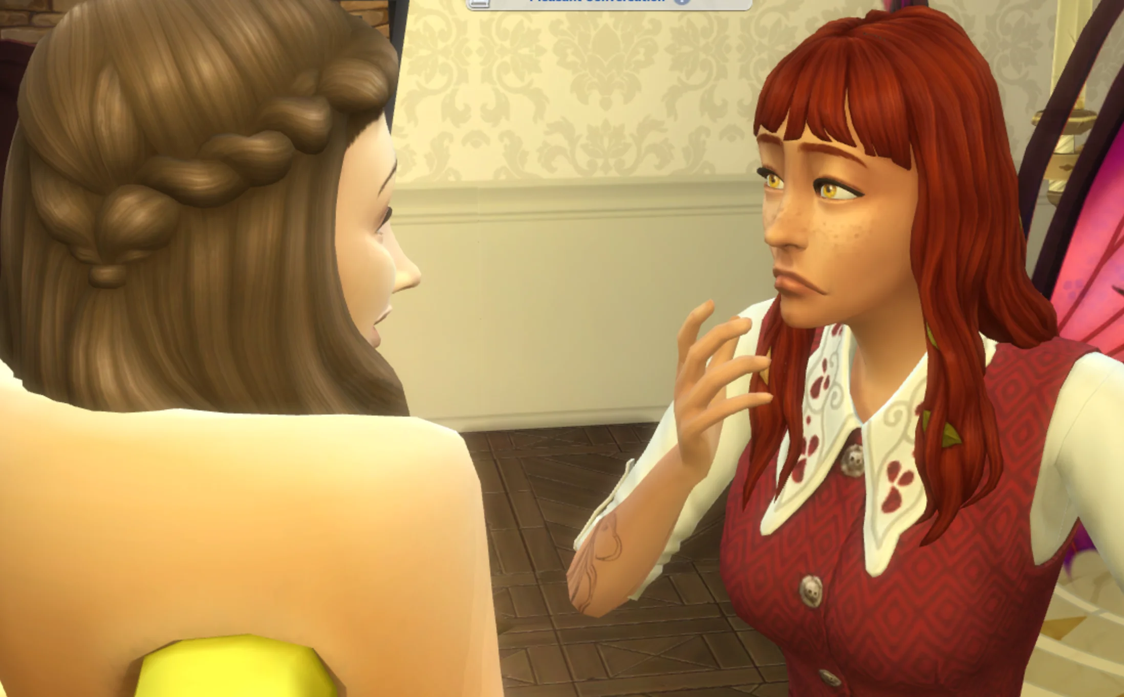 A sim from The Sims 4 with long red hair looking shocked as a sim with brown hair wearing a hotdog suit stands in front of her, after just having told her a shocking secret