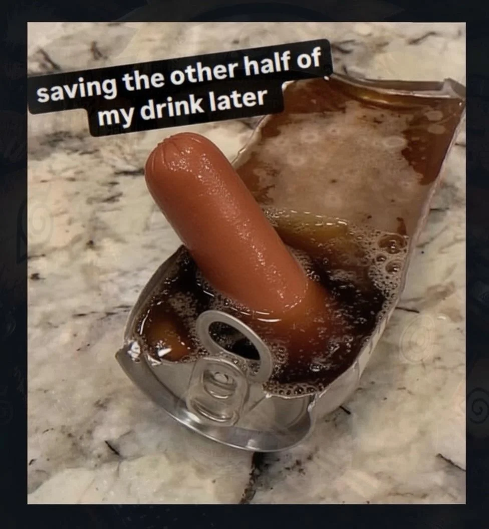 A hot dog is partially submerged in a drink, resembling a can, with a caption that reads "saving the other half of my drink later." The setting appears to be a marble countertop.