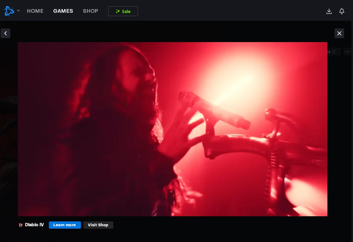 a screenshot of jon davis of korn singing into his mic awash in red light on the diablo 4 page of the battle.net launcher