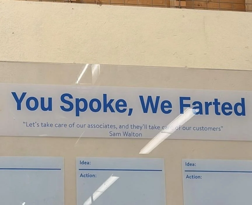 A sign reads "You Spoke, We Farted" with a quote from Sam Walton: "Let's take care of our associates, and they'll take care of our customers." Below, there are sections labeled for "Idea" and "Action."