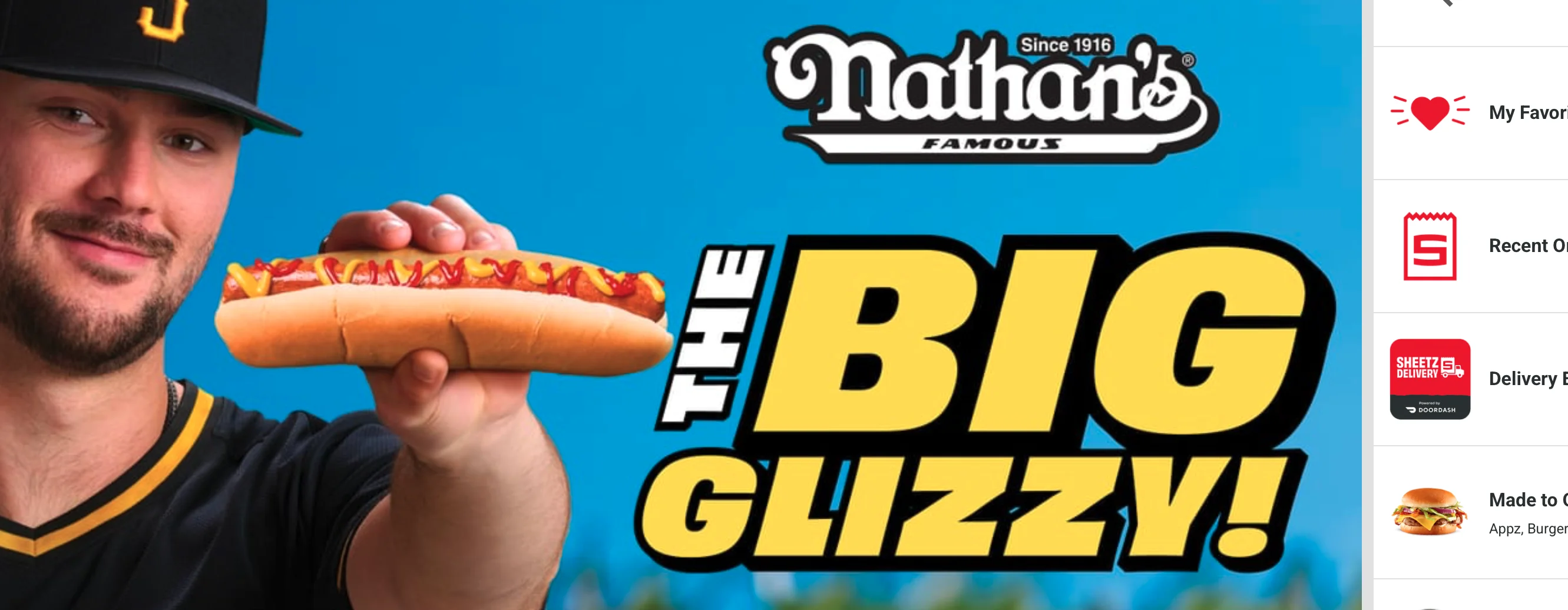 an image from the Sheetz website of a man holding a slightly longer than usual hotdog in a bun with mustard and ketchup, and big yellow text that reads 'NATHAN'S, THE BIG GLIZZY!"