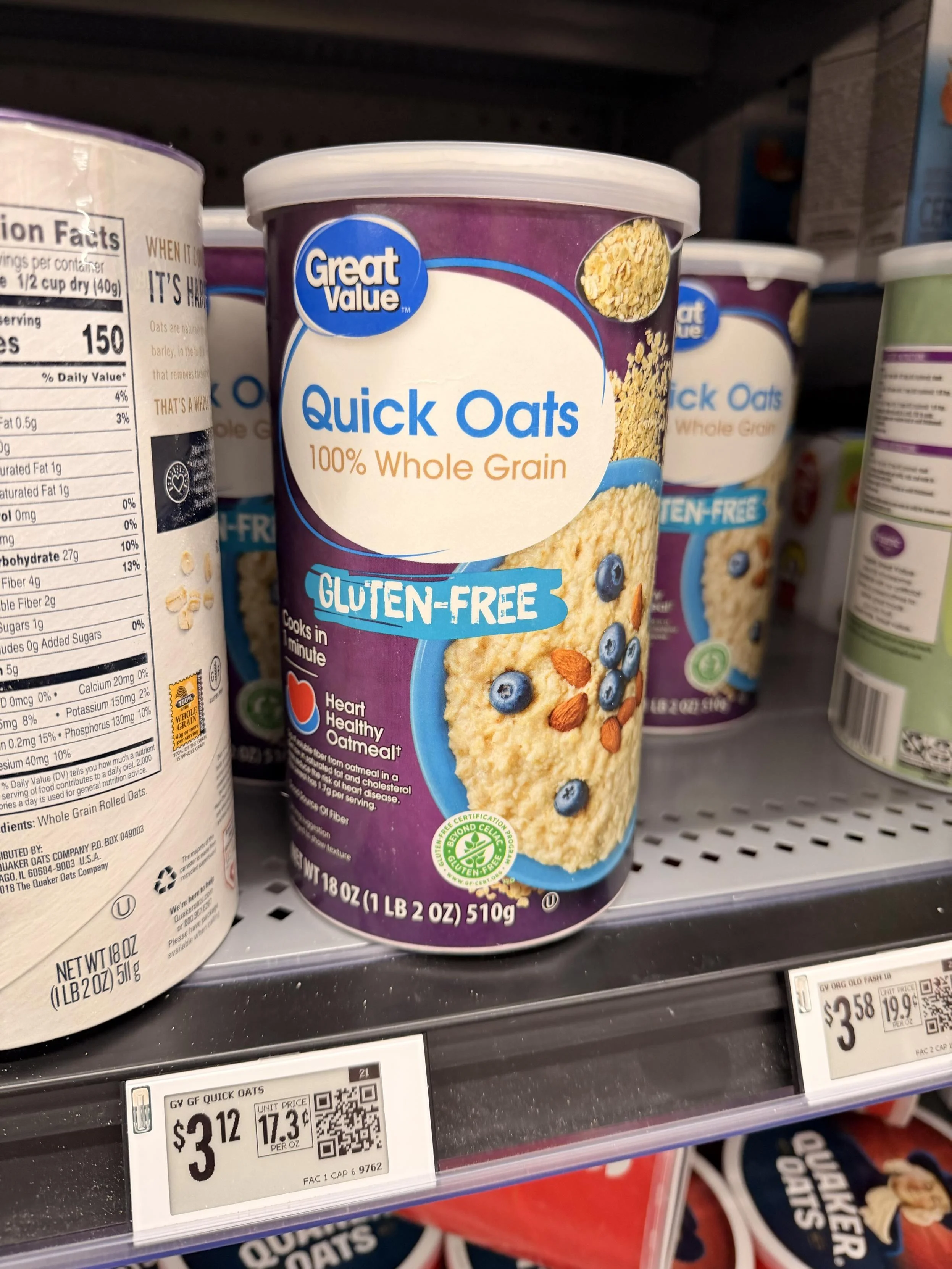 The image features a canister of Great Value Quick Oats, labeled as 100% whole grain and gluten-free. The package highlights its heart-healthy qualities, and blueberries and almonds are depicted on the front. The “gluten free” text is written in an edgy font similar to the piracy commercials from the early 2000s